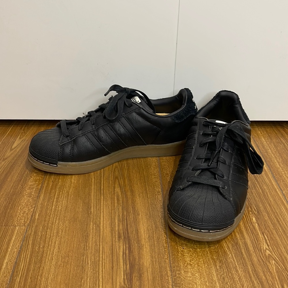 Black Superstar sneakers by Adidas